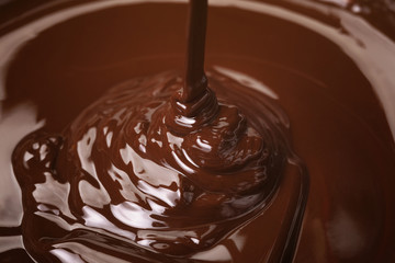 melted dark premium chocolate pour from above, slightly toned photo
