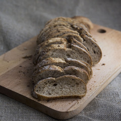 sliced loaf of bread on a board and sacking