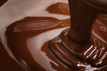 melted dark premium chocolate pour from above, slightly toned photo