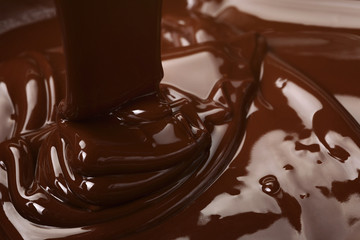 melted dark premium chocolate pour from above, slightly toned photo