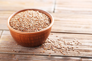 Brown flax seeds on a wooden table