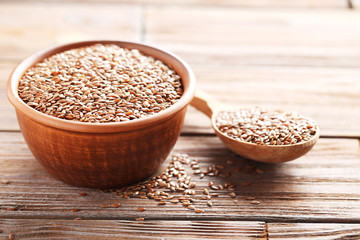 Brown flax seeds on a wooden table