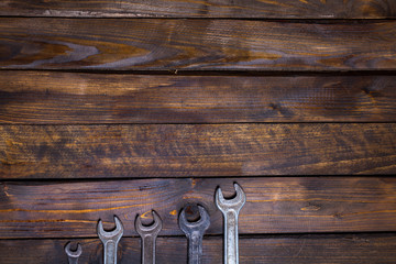 Set various wrenches on wooden background