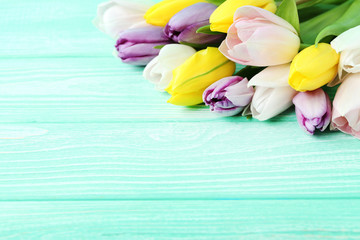 Bouquet of tulips on mint wooden table