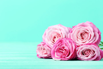 Bouquet of pink roses on a green background
