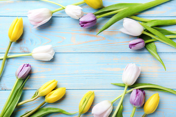 Bouquet of tulips on blue wooden table