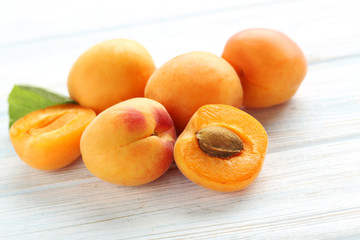 Ripe apricots fruit on white wooden table