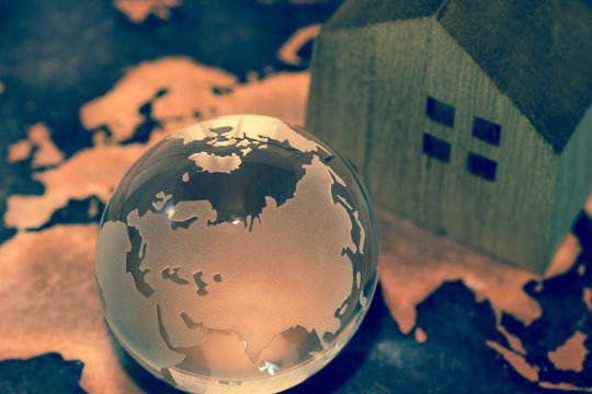 Crystal Globe with House on Grunge World Map