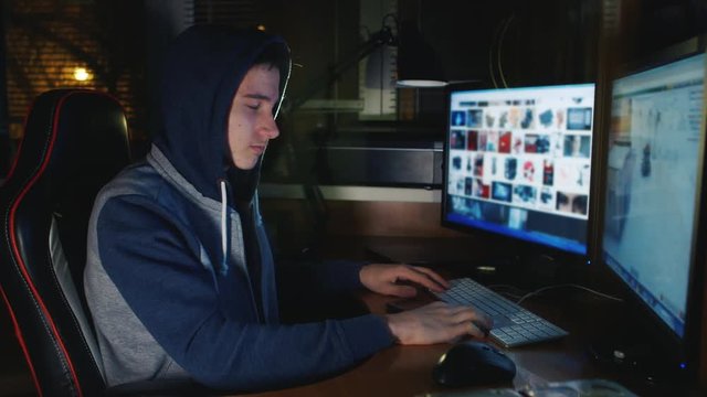 Teenager playing computer games late in the evening. Compulsive gambling among young people
