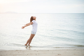 Young beautiful woman standing stretch her arms in the air on th