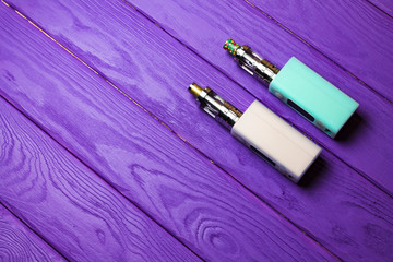 two e-cigarette (electronic cigarette, vape) on the wood backgro