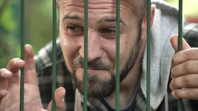  desperate man imprisoned in a cage