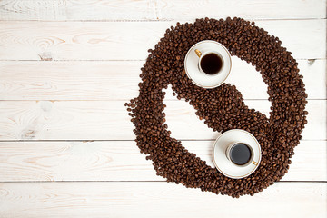 Coffee background. Heap roasted coffee beans in shape of Yin Yan