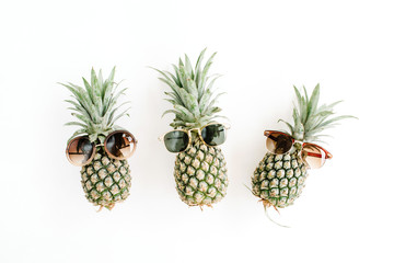 Pineapples in sunglasses. Flat lay, top view