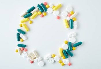 Blister tablets. The capsules are packaged in blisters, isolated on a white background. Disease. Flu. Medications. The tablets are poured out from a vial
