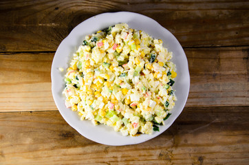 Salad with crab sticks, corn, cucumber, and eggs