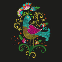 Obraz premium Embroidery colorful ethnic floral pattern. Vector traditional folk bird with flowers ornament on black background.