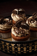 Delicious Oreo cupcakes on dark background. selective focus