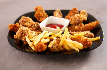 Grilled chicken on a plate standing the wooden table