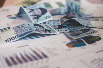 Business concept with money and documents graph on workplace.