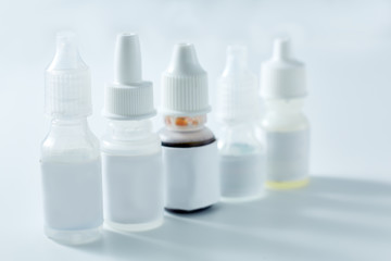 Nasal spray and dropper isolated on white background. Bottles of eye drops, remedy for the common cold isolated on white background.