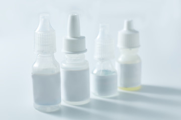 Nasal spray and dropper isolated on white background. Bottles of eye drops, remedy for the common cold isolated on white background.