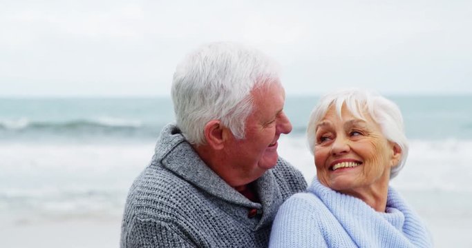 Senior couple embracing each other on the beach