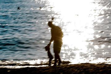 blurred background Silhouette of man  on sea coast 