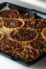 Not baked delicious cakes with nuts on pan.