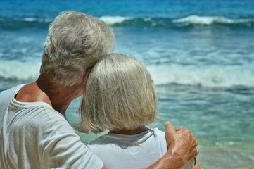 elderly couple rest at tropical beach