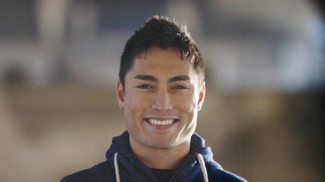4K Portrait of asian male smiling to camera