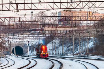 Red diesel engine shunting locomotive on the railroad