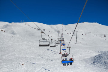 Fototapeta na wymiar Skiers on a ski lift