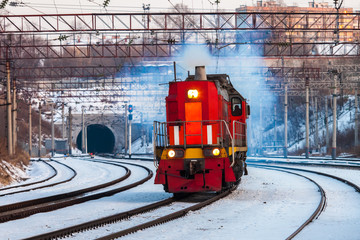 Red diesel engine shunting locomotive on the railroad