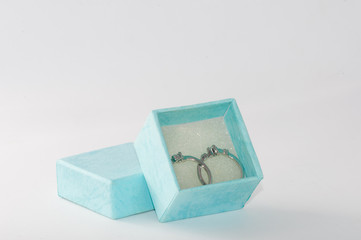 Fototapeta na wymiar Wedding rings and blue box on the white background.