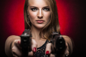 Woman holding two handguns