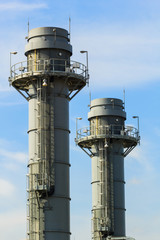Gas turbine electrical power plant at dusk with blue sky