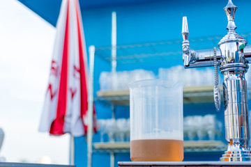 the jar of beer with pump head and faucet