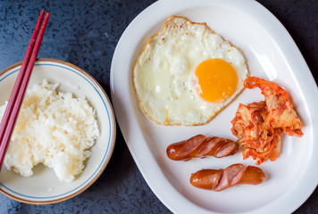 closeup sausage with boil eggs in white dish