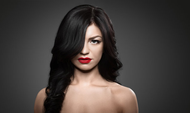 Beautiful brunette woman with shot hairstyle and sexy red lips.