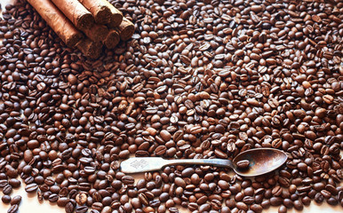 Coffee grains in bulk with an old spoon and several cigars - 134208890