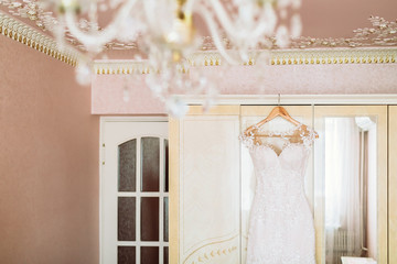 White Wedding dress on a shoulders, before ceremony