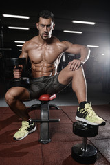 Fototapeta na wymiar man with weight training in gym equipment sport club