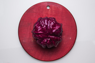 Red cabbage on the red small plank