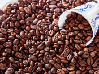 Coffee cup from thin porcelain against the background   grains.