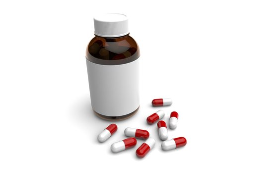 Medication bottle packaging with drug capsules displayed on white surface