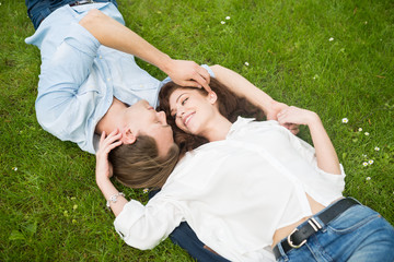 Happy couple relaxing on the grass