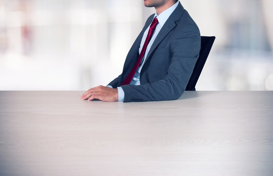 Man leaning on an empty desk. Filtered image