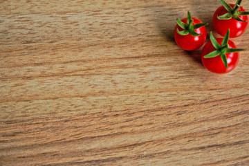 Closeup of ripe cherry tomatoes on a wooden table