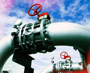 Industrial zone, Steel pipelines and valves against blue sky